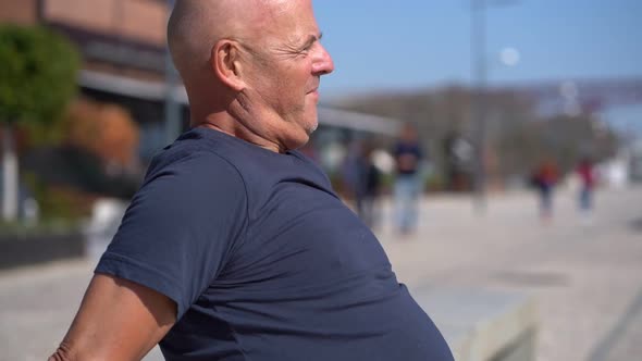 Profile of Concentrated Bald Man Exercising on Street