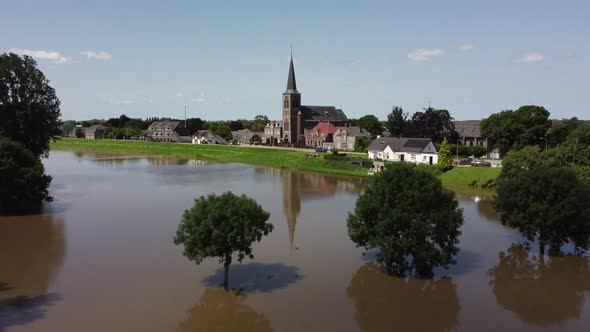 Flooded land and floodplains, drowned trees, river Maas village Appeltern