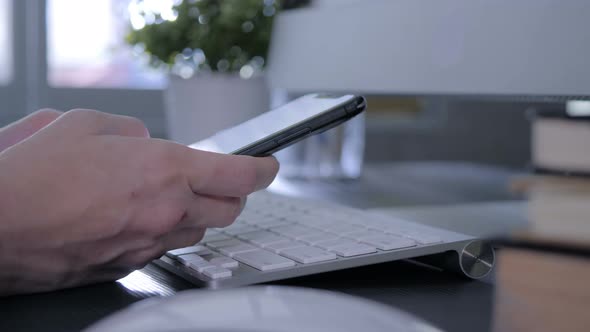 Close Up Female Hand Using Smartphone In Office