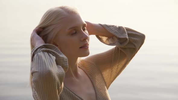 Beautiful Young Woman Looked with Delight at the Sea and Sky on Sunset