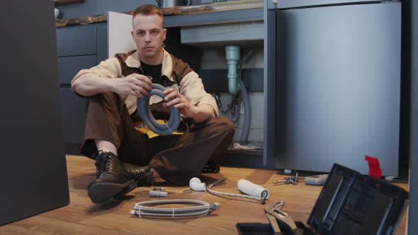 Male Plumber Posing for Camera in Clients House