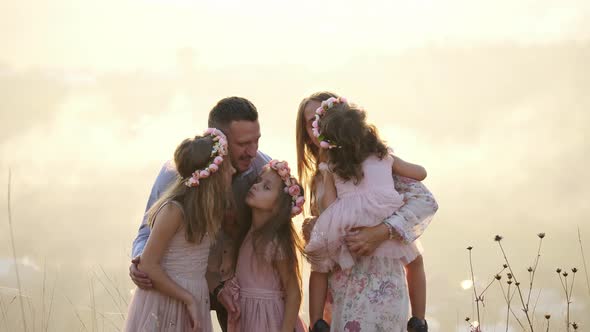 Girls kissing their parents