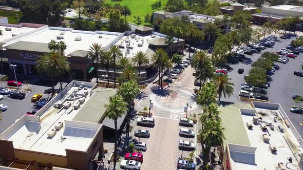 Aerial pull back from a main street shopping mall street