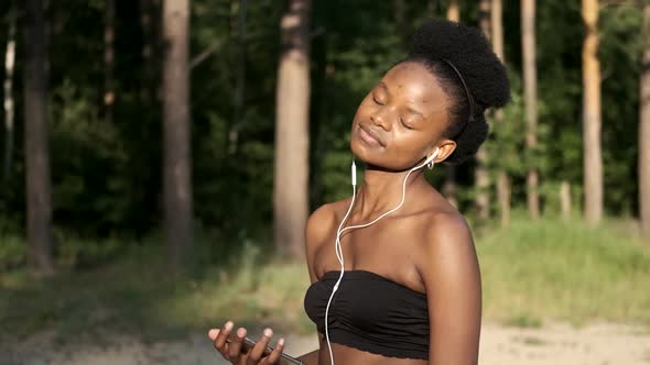 Closeup Black Girl Does Sports Exercises in Nature. Healthy Lifestyle Concept