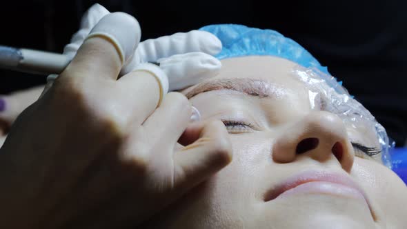 Closeup of Cosmetologist Making Microblading Procedure