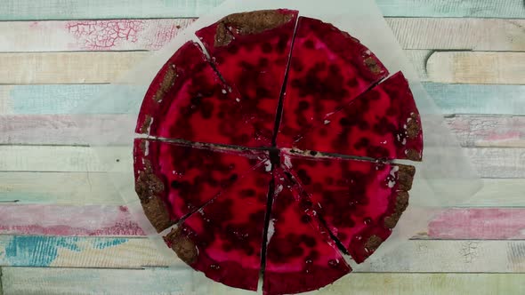 Red Round Jelly Cake Cut Into Pieces, Which are Taken Away. Stop Motion