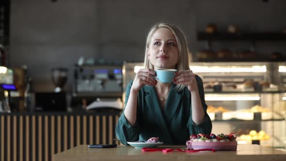 woman drinking a coffee in a cafe, closeup view