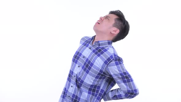 Stressed Young Asian Hipster Man Having Back Pain