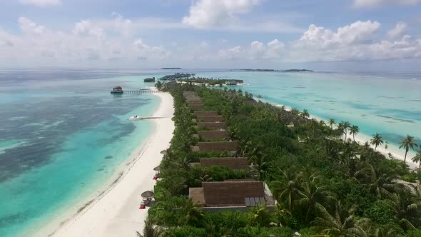 Drone flying above a full of villas in the jungle Maldives island Full HD