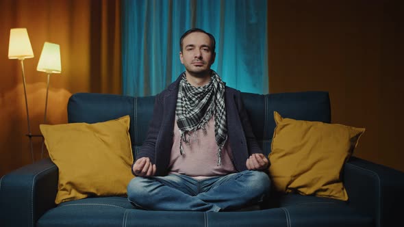 Man Meditates in His Living Room