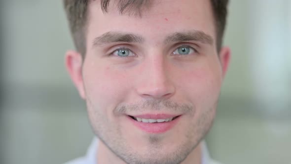 Close Up of Young Man Smiling at the Camera