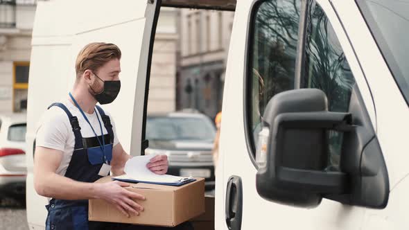 Delivery Driver Checking His List of Parcels