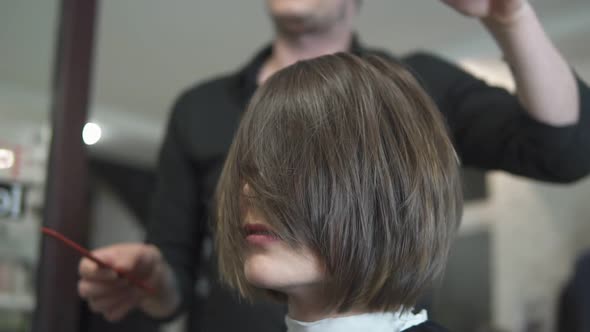 Professional Hair Dresser Using Brush After Haircut