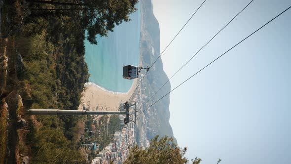 Modern urban cableway at coastline, vertical video. 