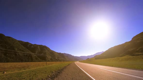 Mountain Road Timelapse at the Summer or Autumn Sunset Sunrise Time. Wild Nature and Rural Field.