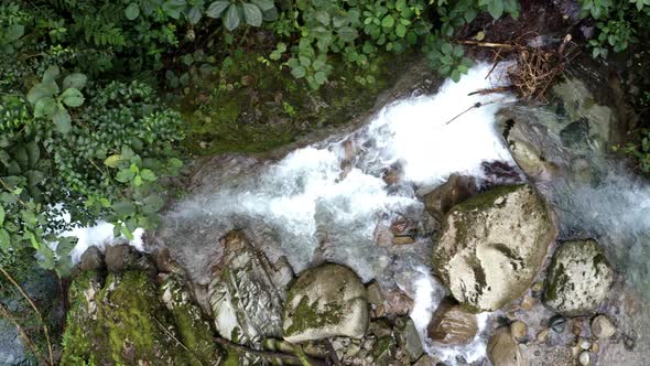 Top view of a stream in the Andes with clear water and rock formations