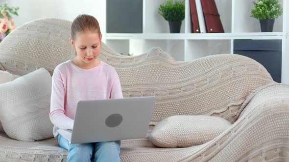 Focused Beautiful Child Girl Chatting in Social Network Typing Message Using Laptop Pc Medium Shot