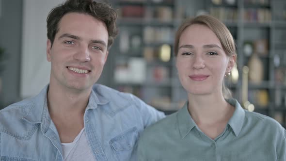 Portrait of Cheerful Couple Looking at the Camera and Laughing