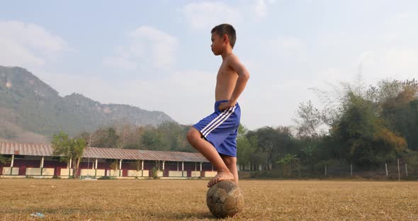 Rural Boy With Old Soccer Ball