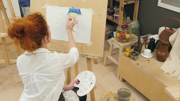 Ginger Female Artist Using Aquarelle To Paint Still Life