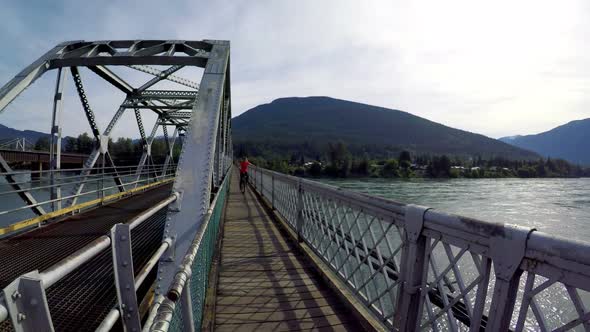 Woman riding unicycle on the bridge 4k