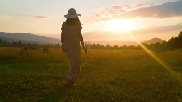 Female in Straw Hat Enjoy Sundown in Rural Area