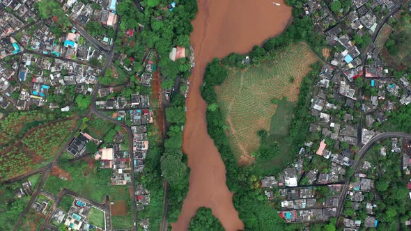 Floods in the Streams Wide Dirty River with Muddy Orange Water and Fields Flooded Pastures