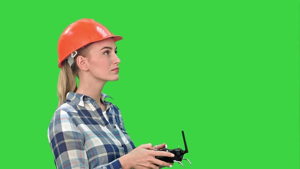 Female Engineer Operating a Drone Analyzing Object on a Green Screen, Chroma Key
