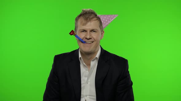 Drunk Disheveled Young Businessman in Festive Cap Celebrates and Sings