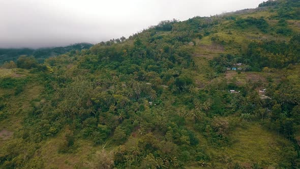 Aerial drone shot flying up the side of a mountainside in central Cebu in the Philippines