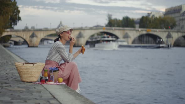 Smiling woman by the Seine, France