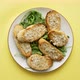 Slices of Garlic Cheese Bread Served on a Plate Arugula Leaves - VideoHive Item for Sale