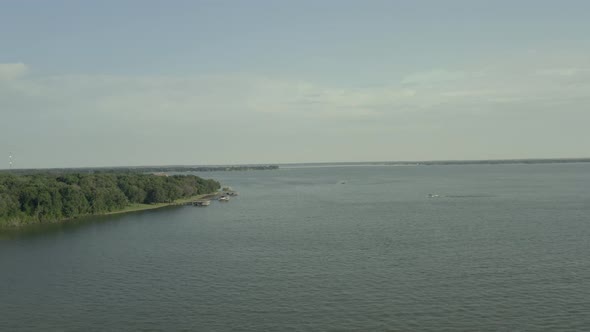 Three docks in the distance of a lake.