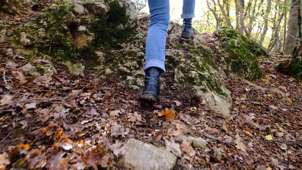 Close Up Follow Shot of Female Boots Walk in Middle of Small Mountain Trail in Forest