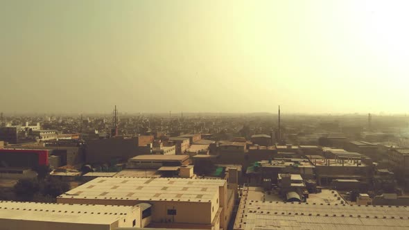 Aerial Over Karachi Cityscape During Golden Yellow Sunrise. Dolly Forward