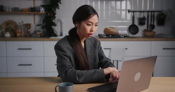 Asian Business Woman Use Laptop and Work From Home in the Evening on Holidays