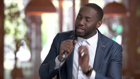 Afro-american Tv Presenter on Blurred Background