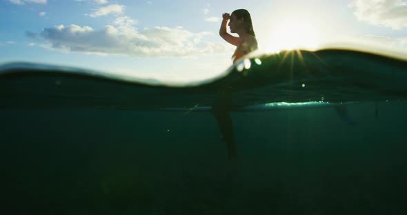 Young Woman Surfing at Susnet