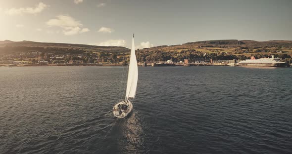 Aerial View of Sun Light on Sail Boat at Ocean Bay Reflection