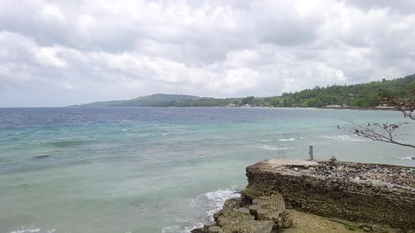 Low flying drone shot over the beach in the small town of Matutinao in Cebu in the Philippines flyin