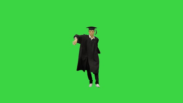 Male Graduate in Robe and Mortarboard Doing Modern Dance and Breakdance on a Green Screen, Chroma