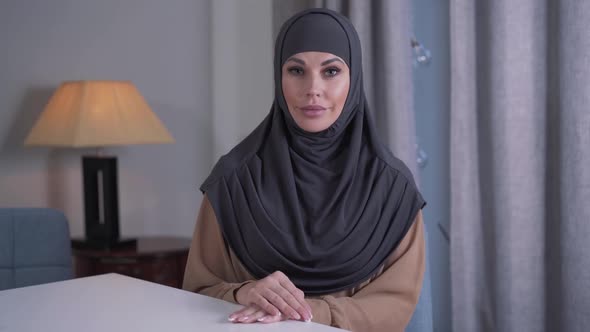 Portrait of Positive Modern Muslim Woman Looking at Camera and Smiling