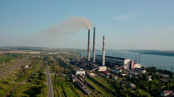 Aerial Drone View of High Chimney Pipes with Grey Smoke From Coal Power Plant. Wide View