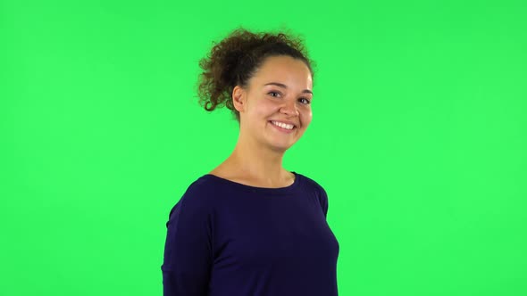 Portrait of Curly Woman Smiling, Revealing Teeth. Green Screen