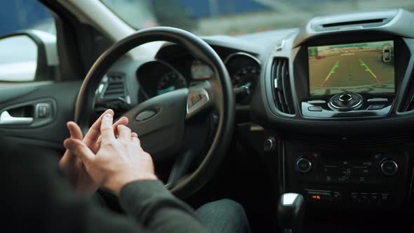 Man Driving in Innovative Automated Car Using Selfparking Autopilot for Parking on Parking Lot