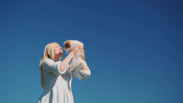 Happy Owner of a Puppy Jumping High Into the Sky