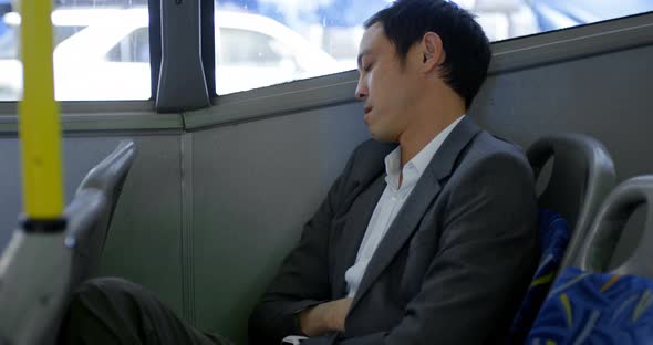 Business commuter sleeping while travelling in bus 4k