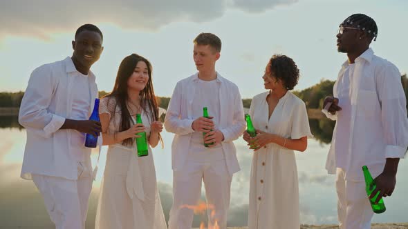 Group of Friends Drinking at the Beach Party and Looking at Camera