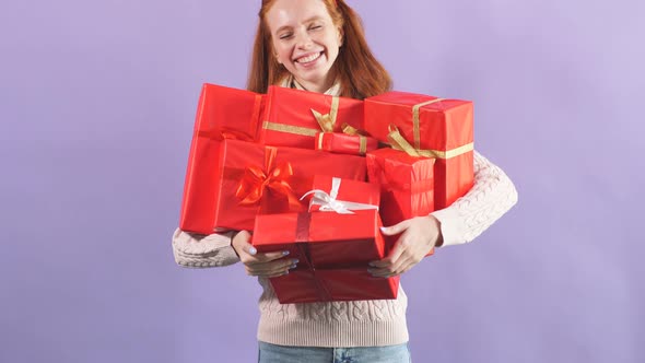 Smiling Playful Girl Holding Many Beautiful Christmas Present