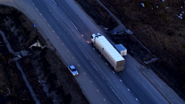 Aerial View of The Truck that Rides on A Huge Interchange at Sunset